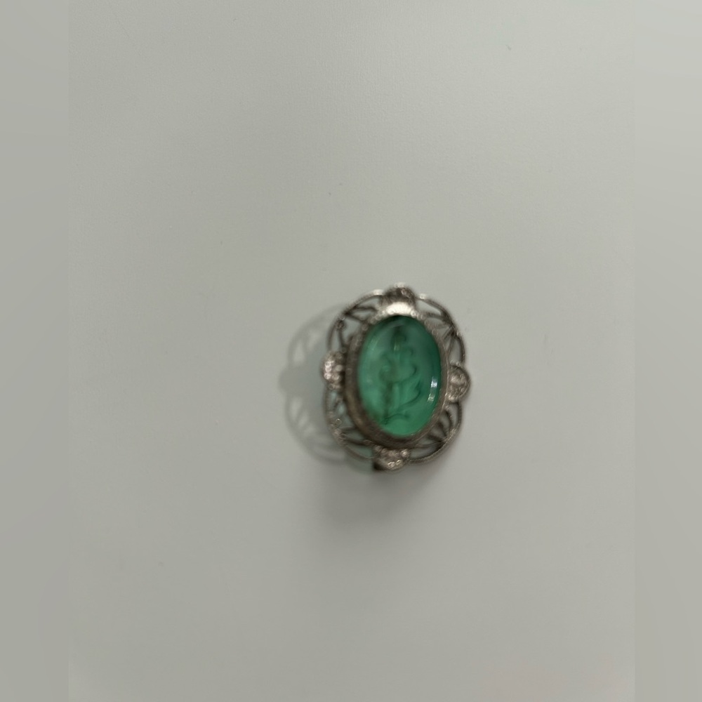 Marcasite silver brooch with green flower intaglio .